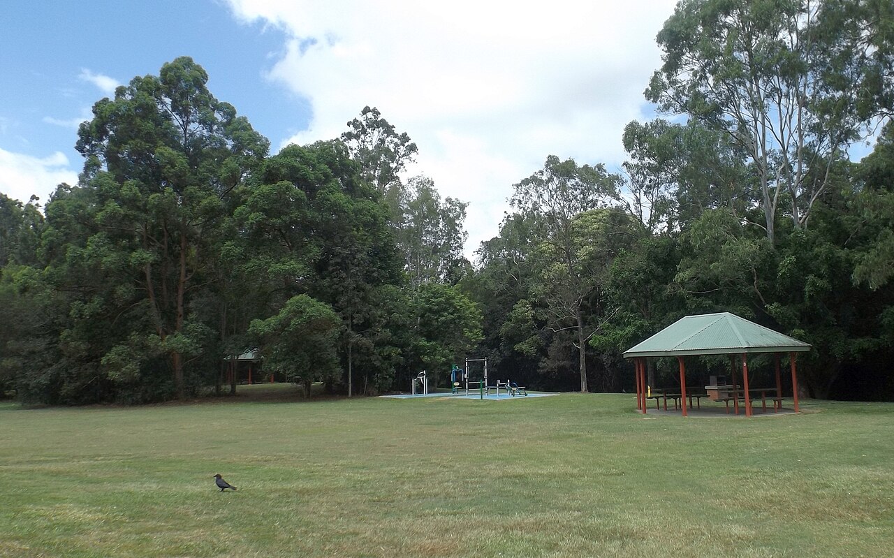 Covered picnic tables and exercise equipment at Alexander Clark Park